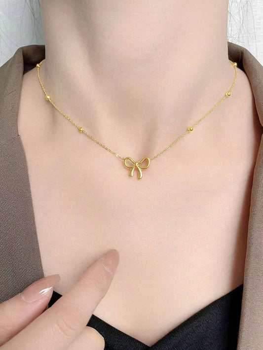 GOLD TONED BOW NECKLACE