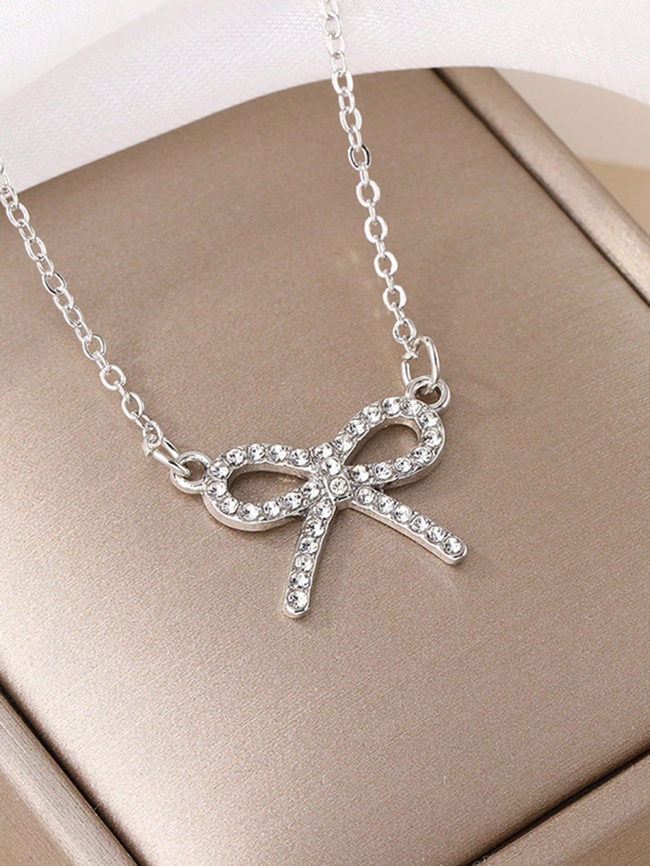 SILVER TONED BOW NECKLACE